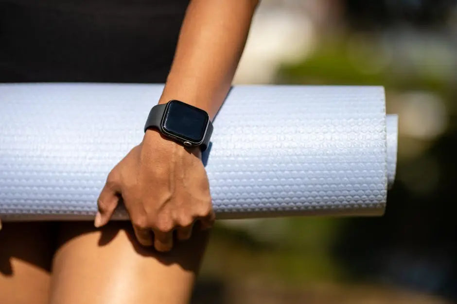 Person holding a white energy healing mat, wearing smartwatch, outdoors wellness concept