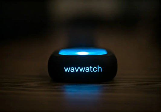 wavwatch energy frequency wellness device with glowing blue light on wood surface
