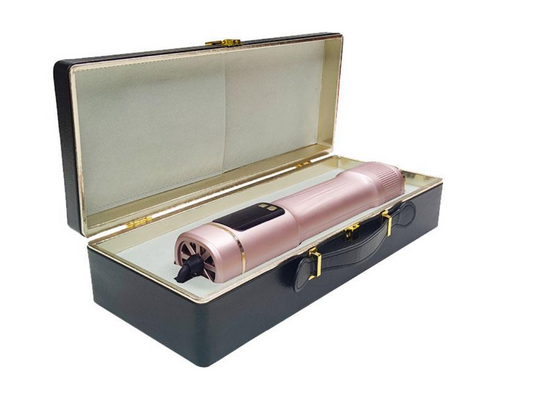 Rose gold hair dryer in a black case on a white background
