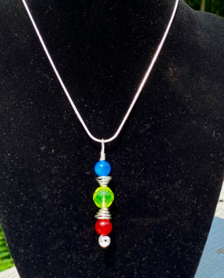 Necklace with colorful beads on a black stand